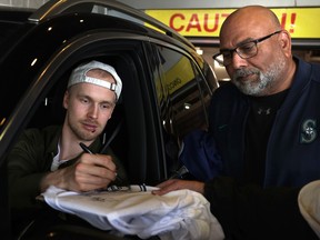 Vancouver Canucks' forward Elias Pettersson signs autographs following an end-of-season media availability at Rogers Arena on Thursday.