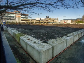 In most major Western cities, especially Metro Vancouver, the price of land now far exceeds the value of the buildings on it. Here, fill covers a parking lot near Vancouver's Burrard Bridge.