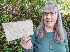 Esquimalt's Sherry Kirkvold holding a postcard she sent herself from the Galapagos Islands 33 years ago. Darren Stone photo.
