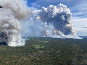 A view of the Parker Lake wildfire near Fort Nelson, B.C. is shown on Monday, May 13, 2024 in a BC Wildfire Service handout photo. British Columbia's wildfire service says there's potential for gusty winds to fan aggressive fire behaviour in the north, where out-of-control have forced several thousand people to leave their homes.