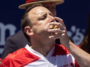 Defending champion Joey Chestnut competes in the Nathan's Famous Fourth of July International Hot Dog Eating Contest in 2023.