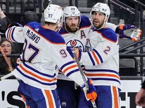 LAS VEGAS, NEVADA - MAY 03: Connor McDavid #97, Leon Draisaitl #29 and Evan Bouchard #2 of the Edmonton Oilers celebrate after McDavid assisted Draisaitl on his second goal of the third period, his fourth goal of the game, against the Vegas Golden Knights in Game One of the Second Round of the 2023 Stanley Cup Playoffs at T-Mobile Arena on May 03, 2023 in Las Vegas, Nevada.