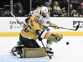 Logan Thompson of the Vegas Golden Knights makes a save against Arshdeep Bains at T-Mobile Arena on April 02, 2024.