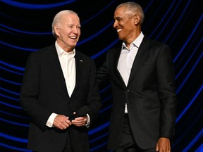 U.S. President Joe Biden stands with former President Barack Obama onstage during a campaign fundraiser at the Peacock Theater in Los Angeles on June 15, 2024.