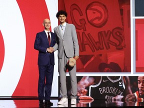 Zaccharie Risacher (R) Shakes hands with NBA commissioner Adam Silver (L) after being drafted first overall pick by the Atlanta Hawks during the first round of the 2024 NBA Draft at Barclays Center on June 26, 2024 in the Brooklyn borough of New York City. NOTE TO USER: User expressly acknowledges and agrees that, by downloading and or using this photograph, User is consenting to the terms and conditions of the Getty Images License Agreement.