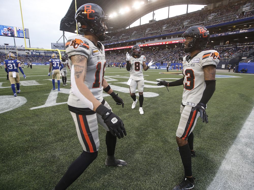 B.C. Lions' Justin McInnis, left, Travis Fulgham, middle, and Alexander Hollins celebrate Hollins' touchdown during second half of Friday's game against the Winnipeg Blue Bombers at Princess Auto Stadium.