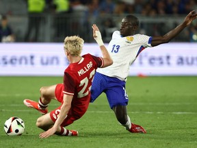 Canada forward Liam Millar (L) and France midfielder N'Golo Kante fight for the ball during the International friendly at the Matmut Atlantique stadium in Bordeaux, on June 9, 2024.