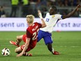 Canada forward Liam Millar (L) and France midfielder N'Golo Kante fight for the ball during the International friendly at the Matmut Atlantique stadium in Bordeaux, on June 9, 2024.