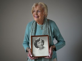 Vi Roden, who turned 101 on June 16, holds a photo of herself when she was 17, while posing for a photograph at her home in West Vancouver, on Friday, June 14, 2024.