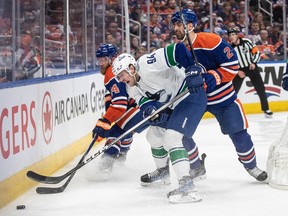 Linus Karlsson (94) battles for the puck against the Edmonton Oilers during the second round of the playoffs on May 12, 2024