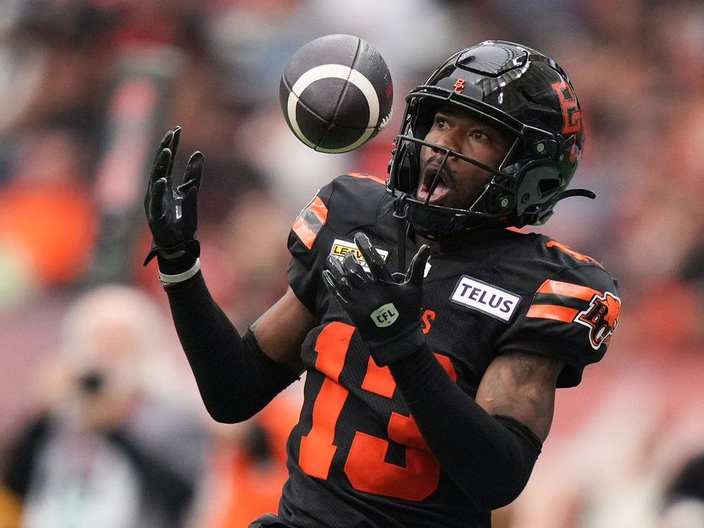 B.C. Lions' Alexander Hollins bobbles the ball and fails to make the catch during the first half of a CFL game against the Calgary Stampeders in Vancouver on June 15.