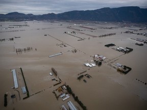 The federal government estimates it will need to pay almost $3.4 billion for its share of the disaster recovery bills for flooding and landslides that devastated British Columbia's Fraser Valley in November 2021. Flooded farmland is seen in an aerial view from a Canadian Forces reconnaissance flight in Abbotsford.