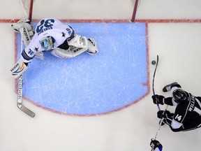 Los Angeles Kings right wing Justin Williams, right, scores against San Jose Sharks goalie Alex Stalock during the first period in Game 6 of an NHL hockey first-round playoff series, Monday, April 28, 2014, in Los Angeles. THE CANADIAN PRESS/AP