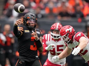 Leading the B.C. Lions to their first win of the season earned quarterback Vernon Adams Jr. the nod as top offensive player on the CFL honour roll Tuesday. Adams Jr., left, passes while being pursued by Calgary Stampeders' Micah Teitz during the first half of a CFL football game, in Vancouver, on Saturday, June 15, 2024.