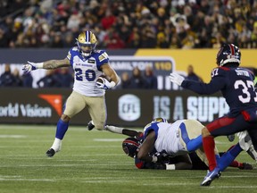 Winnipeg Blue Bombers running back Brady Oliveira (20) runs the ball as Montreal Alouettes defensive back Wesley Sutton (37) defends during the first half of 110th CFL Grey Cup football action in Hamilton, Ont., on Sunday, November 19, 2023.