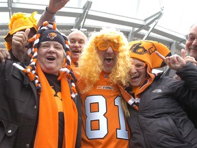 Decked out BC Lions fans having fun in front of BC Place.