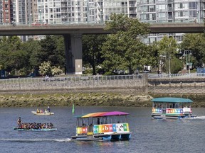 Dragonboat competitors practice for the weekend races while passenger ferries ply the same waters in False Creek.