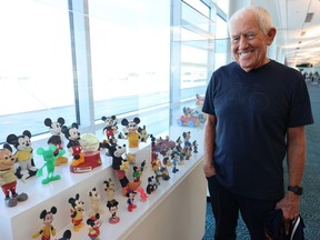 Ken Stephens with examples of his Disney toy collection at the Vancouver airport on June 7.