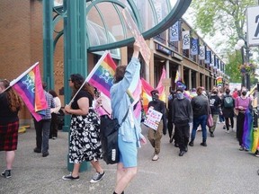 Around 80 protesters with flags and signs in support of LGBTQ+ rights gather at the Victoria Conference Centre where the Reclaiming Canada conference is being held.