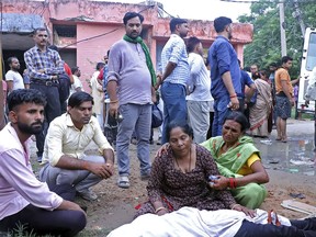 Women mourn next to the body of a relative outside the Sikandrarao hospital in Hathras district about 350 kilometers (217 miles) southwest of Lucknow, India, Tuesday, July 2, 2024. At least 60 people are dead and scores are injured after a stampede at a religious gathering of thousands of people in northern India, officials said Tuesday.