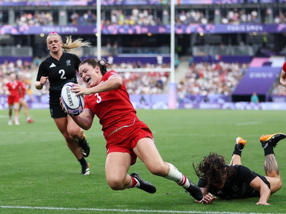 Alysha Corrigan #3 of Team Canada scores her team's second try whilst under pressure from Portia Woodman-Wickliffe #11 of Team New Zealand.