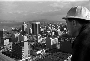 Feb 24, 1967. A worker checks out the view from the top of the Blue Horizon Hotel at Bute and Robson, looking northeast toward downtown and the waterfront.