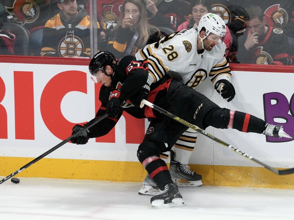Boston Bruins defenceman Derek Forbort ties up Ottawa Senators centre Shane Pinto during first period NHL action, Thursday, January 25, 2024 in Ottawa.