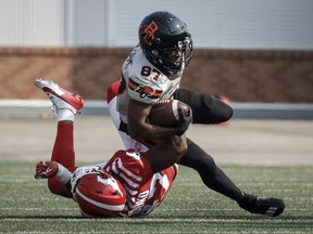 B.C. Lions Terry Williams (87) is tackled by Calgary Stampeders George Idoko (47) during first half CFL football action in Calgary, Alta., Sunday, July 21, 2024.