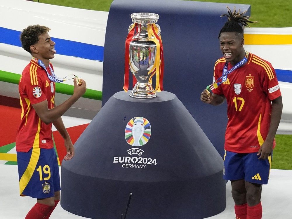 Young Spanish stars Lamine Yamal, left, and Nico Williams celebrate after Spain won Euro 2024 in Berlin on Sunday.