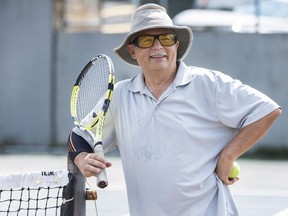 Ted Debicki plays tennis with his son Matt in North Vancouver. As the weather heats up, so does demand for the city's sports courts.