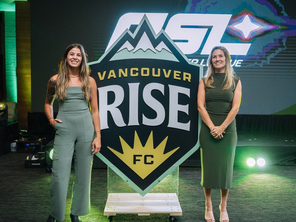 Vancouver Rise FC sporting director Stephanie Labbé (left) and president Sinead King unveil the logo for the city's new professional women's soccer team on Monday.