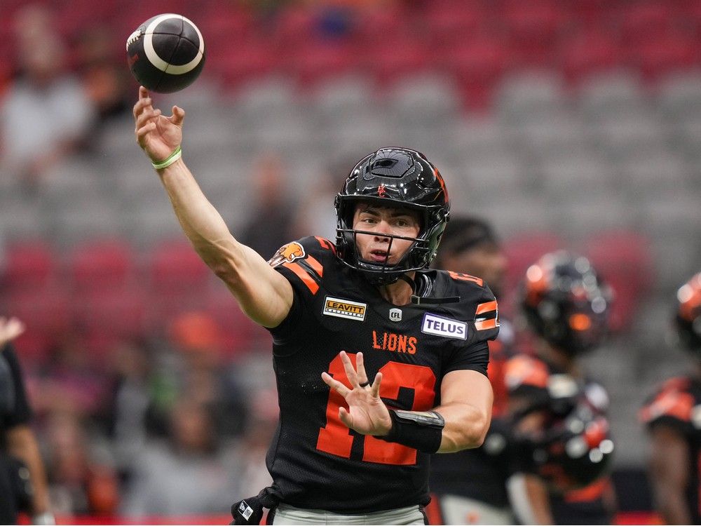 Nathan Rourke passes while warming up before the game