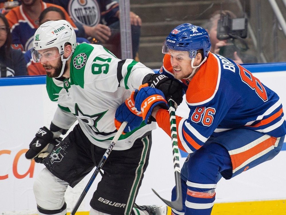 Philip Broberg (86) of the Edmonton Oilers, holds on to Tyler Seguin (91) of the Dallas Stars at Rogers Place in Edmonton on June 2, 2024.