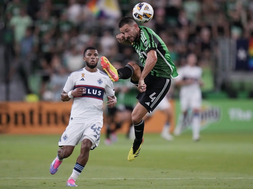 Austin FC defender Brendan Hines-Ike (4) moves the ball pass Vancouver Whitecaps midfielder Pedro Vite (45) during the second half of an MLS soccer match in Austin, Texas, Saturday, Aug. 31, 2024.