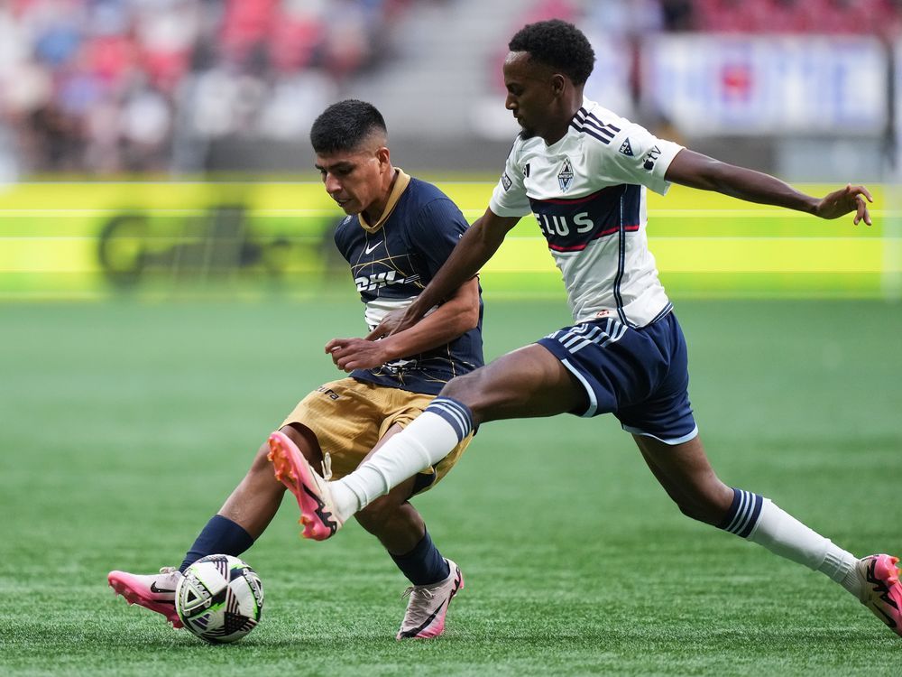 Pumas UNAM's Piero Quispe, back left, and Vancouver Whitecaps' Ali Ahmed vie for the ball during the first half of a Leagues Cup soccer match, in Vancouver on August 7, 2024.