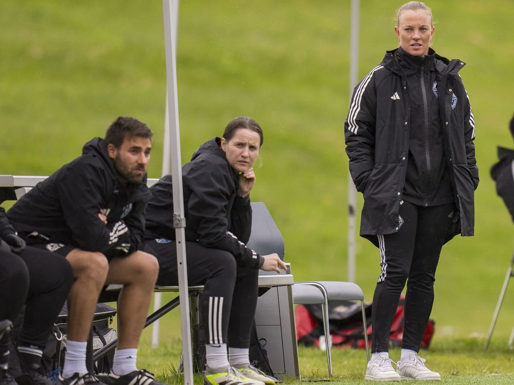 Katie Collar (right), head coach of the Vancouver Whitecaps FC League1 BC women's team, is shown (standing) on the sidelines May 5, 2024, in a game against TSS Rovers at Thunderbird Stadium in Vancouver.