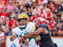 Edmonton Elks quarterback McLeod Bethel-Thompson throws a pass while under pressure from Calgary Stampeders defensive lineman James Vaughters during the Labour Day Classic at McMahon Stadium on Monday September 2, 2024.