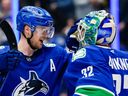 Elias Pettersson and Kevin Lankinen celebrate after defeating the Maple Leafs on Feb. 8 at Rogers Arena.