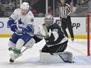 Kings goaltender Darcy Kuemper deflects a shot on goal by Vancouver centre Pius Suter during a game in November.