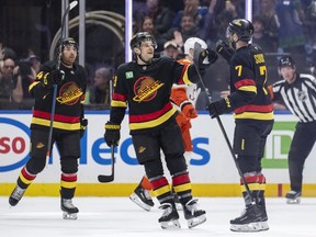 Vancouver Canucks' Teddy Blueger and Kiefer Sherwood