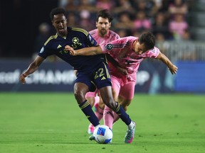 Ali Ahmed #22 of the Vancouver Whitecaps FC and Tadeo Allende #21 of Inter Miami CF battle for the ball during the CONCACAF Champions Cup Semi-final Second Leg match between Inter Miami CF and Vancouver Whitecaps at Chase Stadium on April 30, 2025 in Fort Lauderdale, Florida.