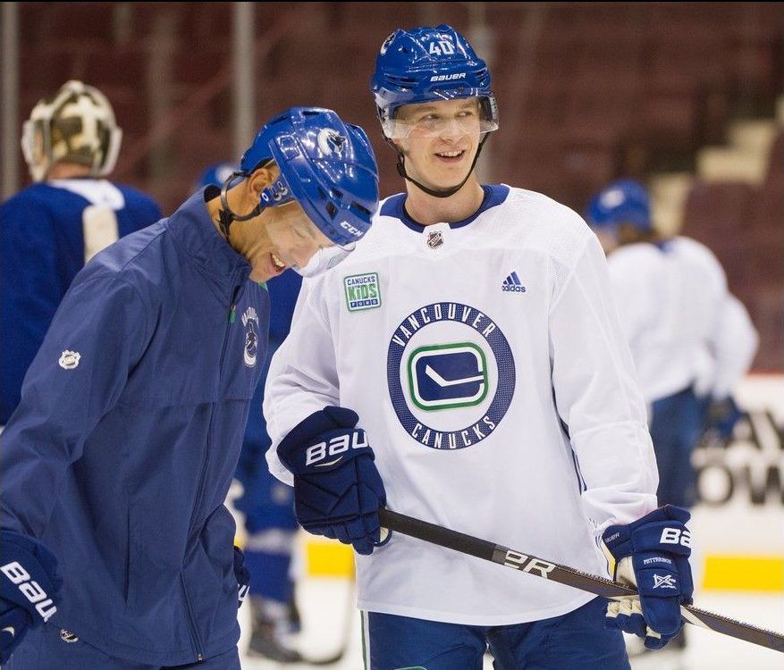 Canucks assistant coach Manny Malhotra shares laugh with Elias Pettersson during Oct. 23, 2018, practice at Rogers Arena.