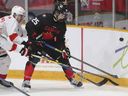 Canada's Matthew Schaefer, right, battles for the puck with Switzerland's Basile Sansonnens during the third period of an IIHF World Junior Hockey Championship pre-tournament game.