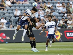Jeevan Badwal heads the ball against Timothy Tillman of Los Angeles FC at BMO Stadium on June 29, 2025 in Los Angeles, California.