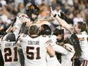 B.C. Lions' Sean Whyte, top left, celebrates with teammates after kicking the winning field goal during second half CFL football action against the Montreal Alouettes in Montreal, Saturday, July 5, 2025.