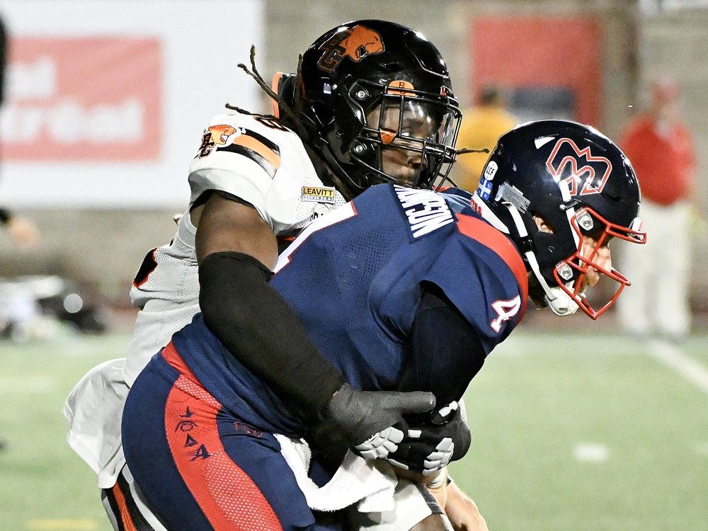 B.C. Lions' Kemoko Turay, left, tackles Montreal Alouettes quarterback McLeod Bethel-Thompson (4) during second half CFL football action in Montreal, Saturday, July 5, 2025.