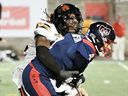B.C. Lions' Kemoko Turay, left, tackles Montreal Alouettes quarterback McLeod Bethel-Thompson (4) during second half CFL football action in Montreal, Saturday, July 5, 2025.