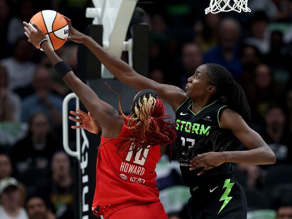 Ezi Magbegor of the Seattle Storm blocks a shot by Rhyne Howard of the Atlanta Dream at Climate Pledge Arena on Aug. 13 in Seattle.