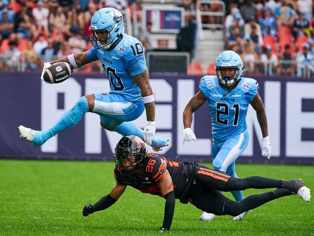 Argonauts wide receiver Kevin Mital evades a tackle from B.C. Lions defensive back Robert Carter Jr. during Saturday's game in Toronto.
