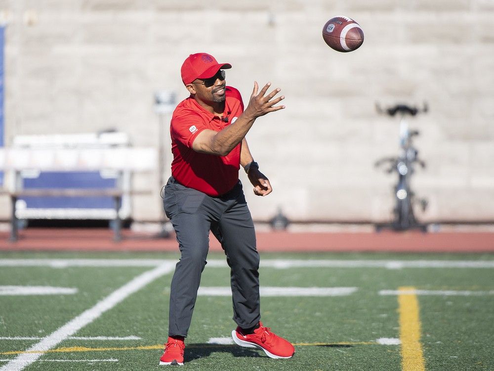 Then-Alouettes coach Khari Jones catches a ball prior to a pre-season game against the Ottawa Redblacks in 2022.